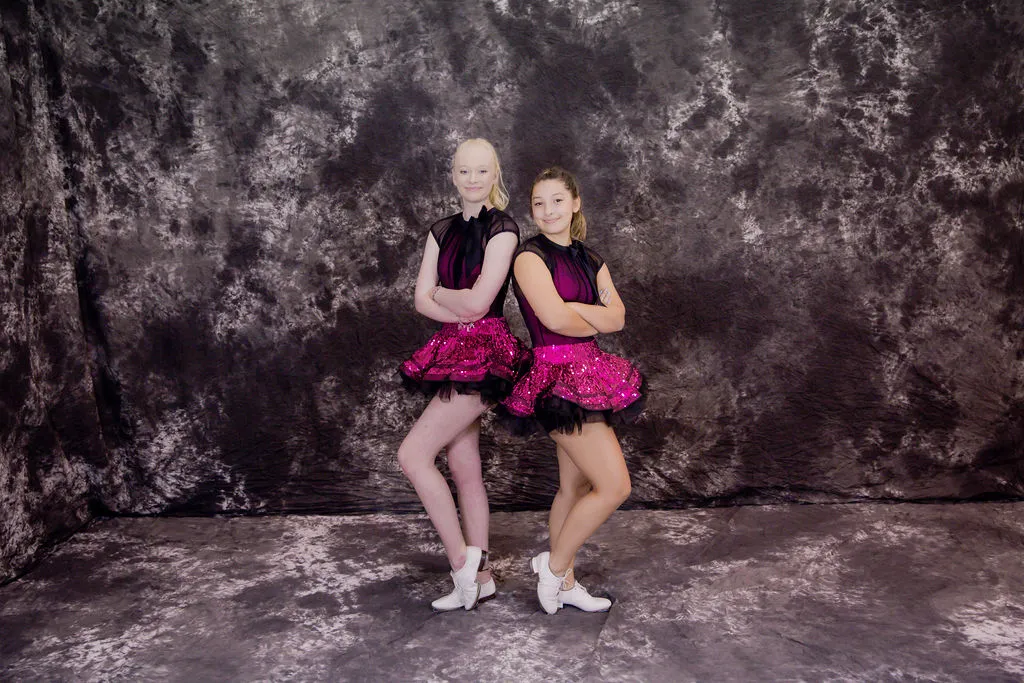 Two dancers in pink costumes