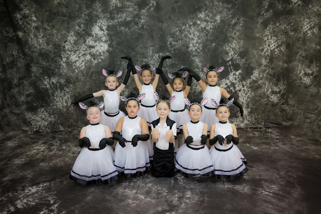 Young ballet dancers in white tutus